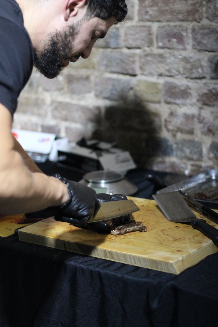 Chef carving steak on the board