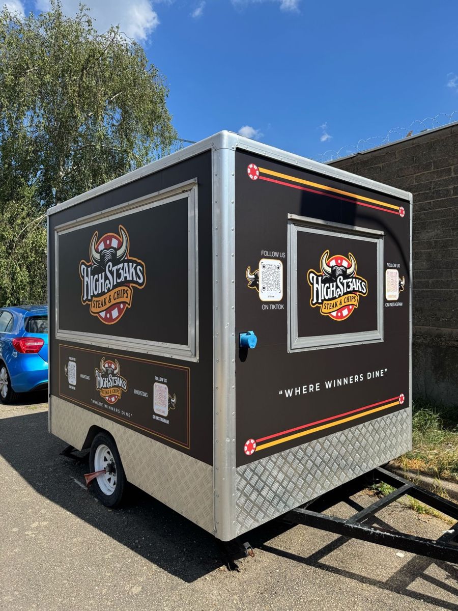 The High St3aks trailer, wrapped in black with gold and red stripes
